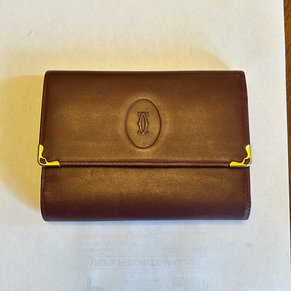 Cartier Handbags - Cartier Bordeaux leather kisslock trifold wallet